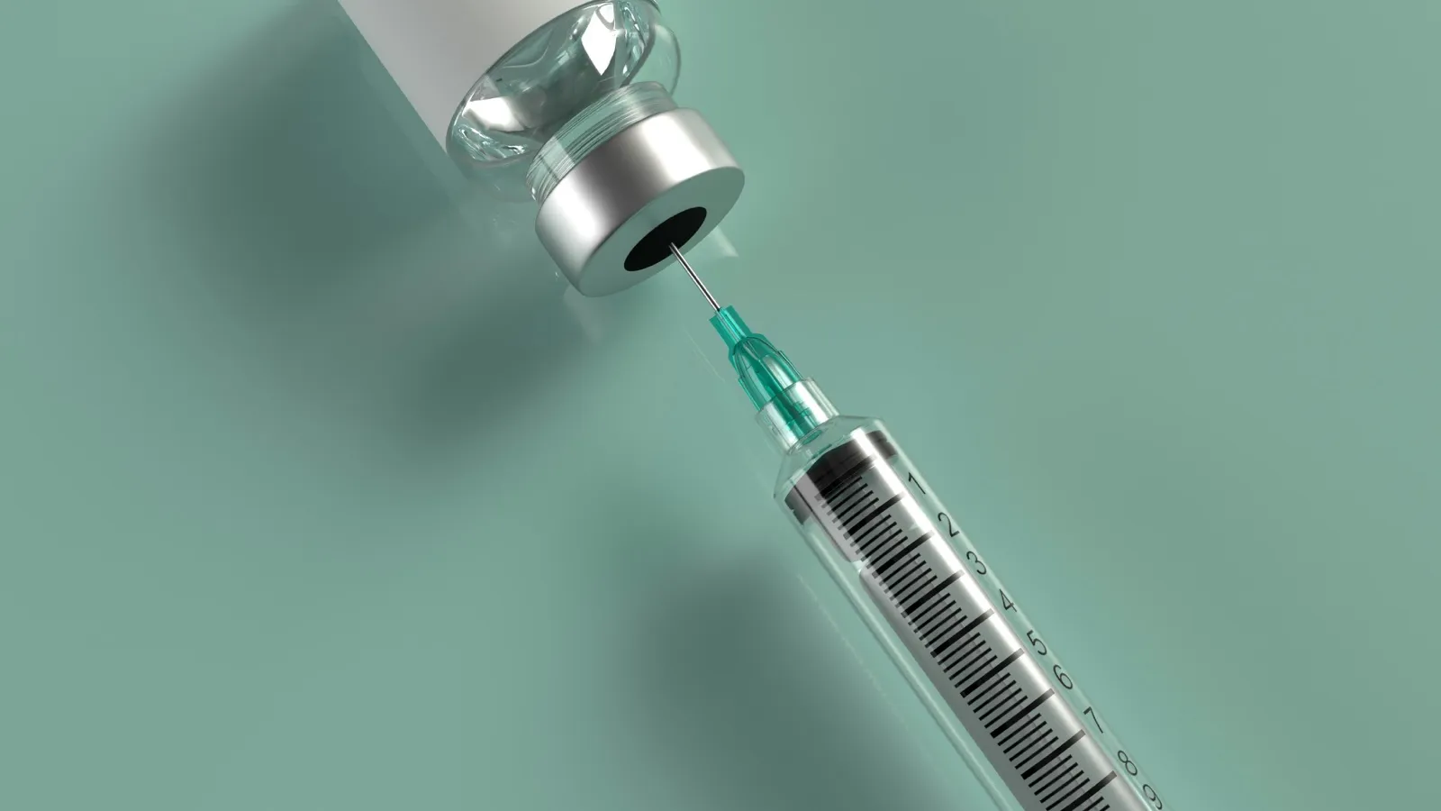 Syringe drawing medication from an injection vial